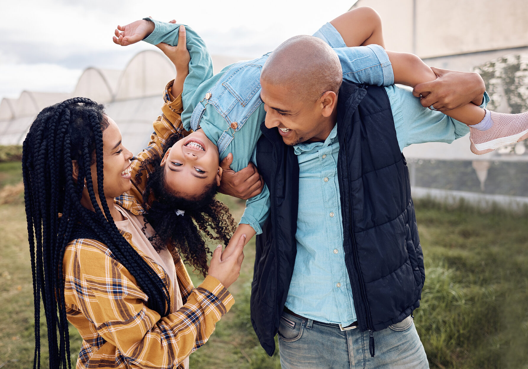 Black family, farm or fun with a girl, mother and father playing outdoor on a field for agriculture.